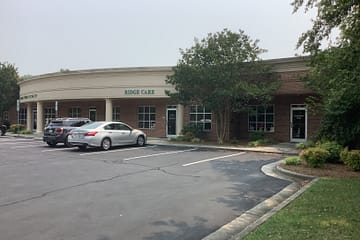 office condo with parking lot and cars parked out front