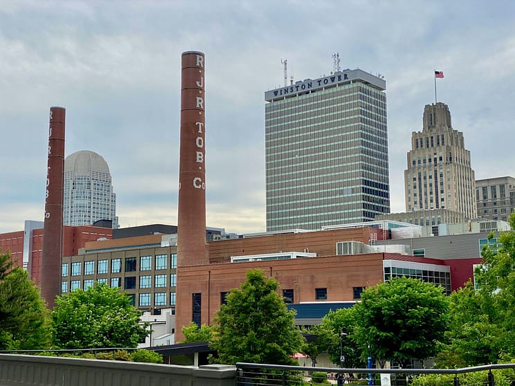 city skyline with trees dotting the front of the buildings